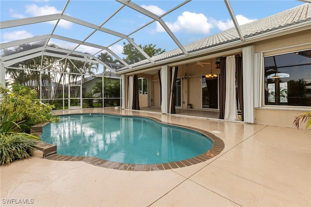 view of swimming pool featuring a patio area and glass enclosure