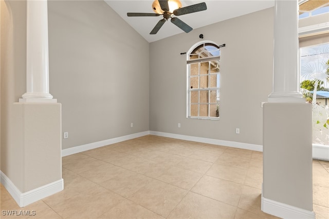 empty room with light tile patterned flooring, a wealth of natural light, ceiling fan, and lofted ceiling