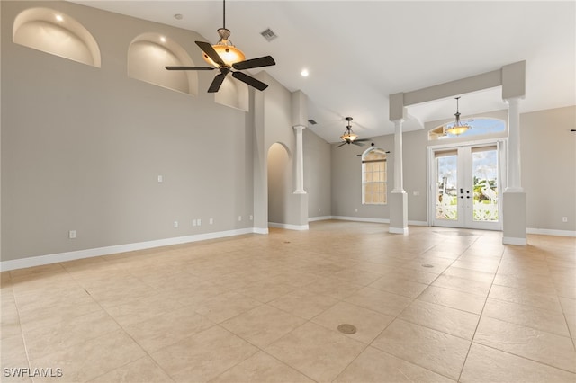 unfurnished living room with high vaulted ceiling, french doors, light tile patterned floors, and ceiling fan