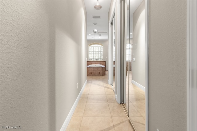 corridor featuring light tile patterned flooring