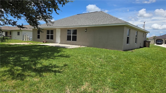 rear view of property with a lawn