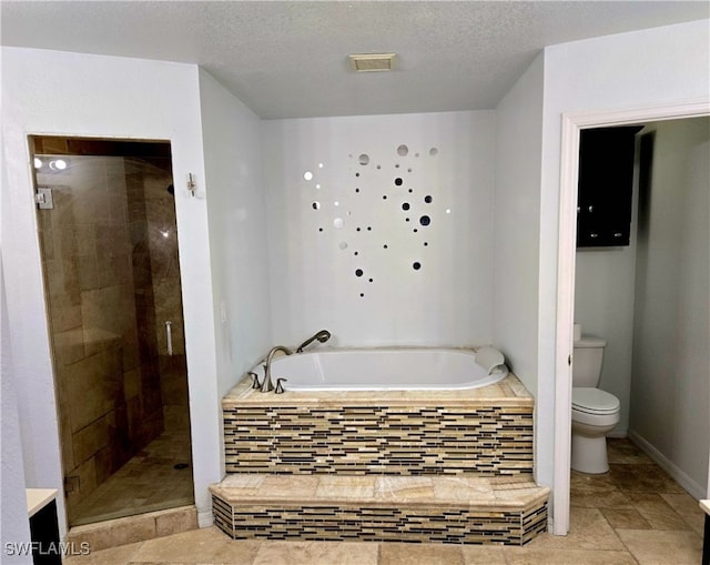 bathroom featuring independent shower and bath, tile patterned flooring, toilet, and a textured ceiling