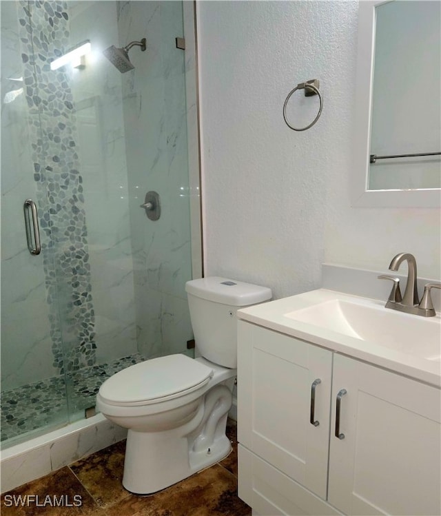 bathroom with vanity, toilet, and an enclosed shower