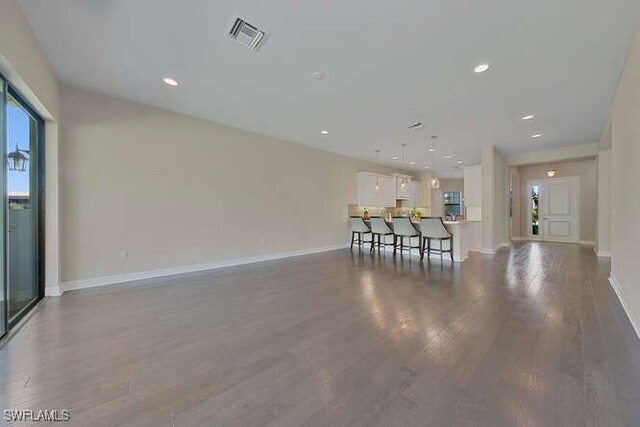 unfurnished living room with wood-type flooring