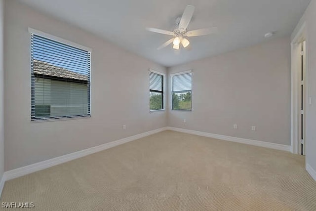 carpeted empty room featuring ceiling fan