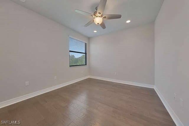 spare room featuring ceiling fan and dark hardwood / wood-style floors