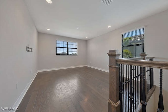 unfurnished room featuring dark wood-type flooring