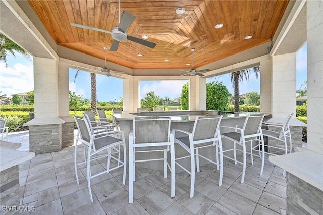 view of patio / terrace featuring a bar and ceiling fan