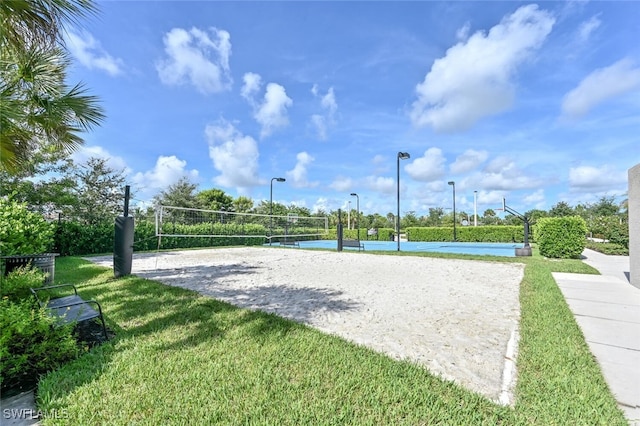 view of home's community featuring volleyball court and a yard