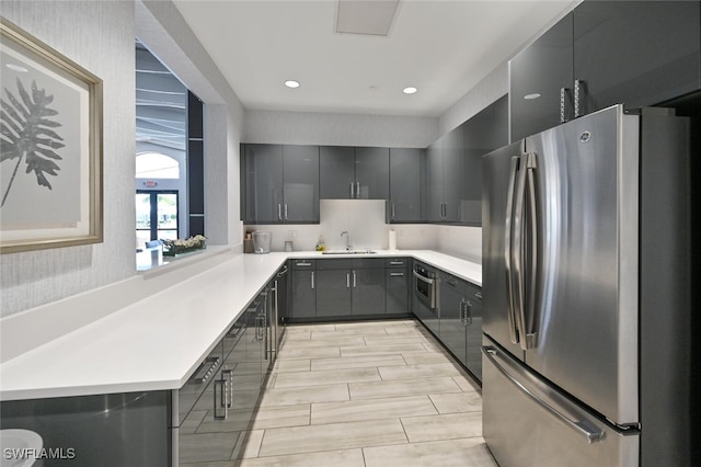 kitchen with stainless steel fridge and sink