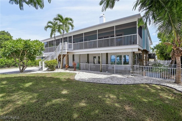 8335 Main St, Bokeelia, FL 33922 - rear view of house with a sunroom, stairway, a lawn, french doors, and fence