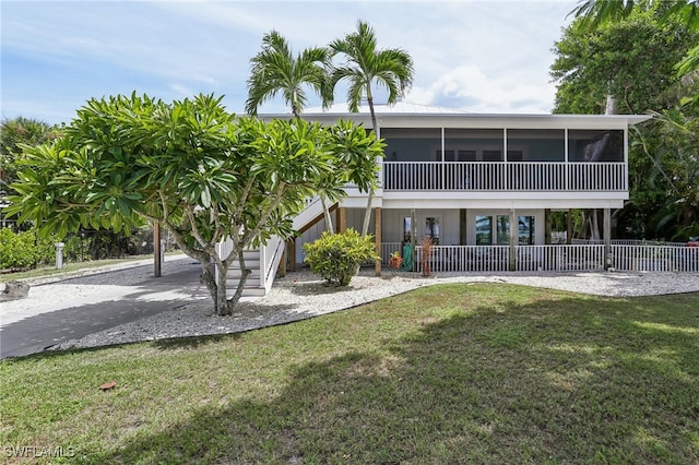 back of house featuring a lawn and a carport