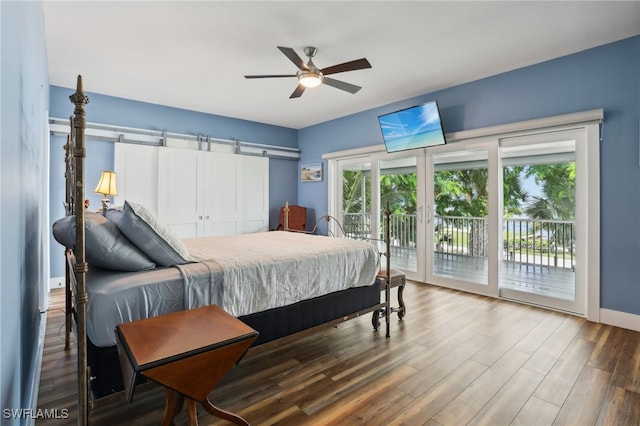 bedroom with ceiling fan, wood-type flooring, multiple windows, and access to outside