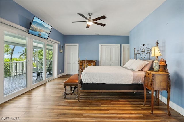 bedroom featuring hardwood / wood-style floors, two closets, access to exterior, and ceiling fan