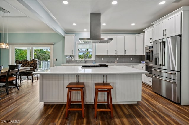 kitchen featuring appliances with stainless steel finishes, island range hood, dark hardwood / wood-style floors, and a center island