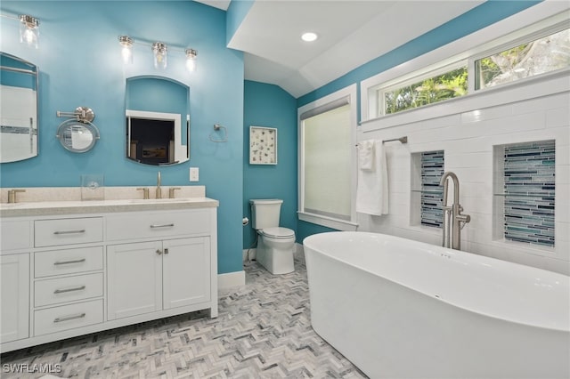 bathroom with double vanity, parquet flooring, vaulted ceiling, toilet, and a washtub