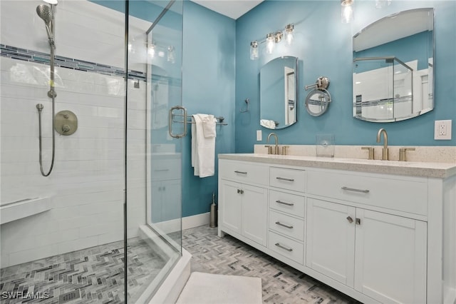 bathroom featuring parquet floors, dual vanity, and a shower with shower door