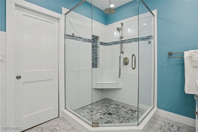 bathroom featuring a shower with shower door and tile patterned floors