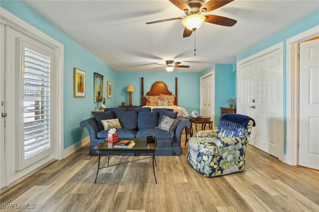 living room featuring light hardwood / wood-style flooring, a healthy amount of sunlight, and ceiling fan