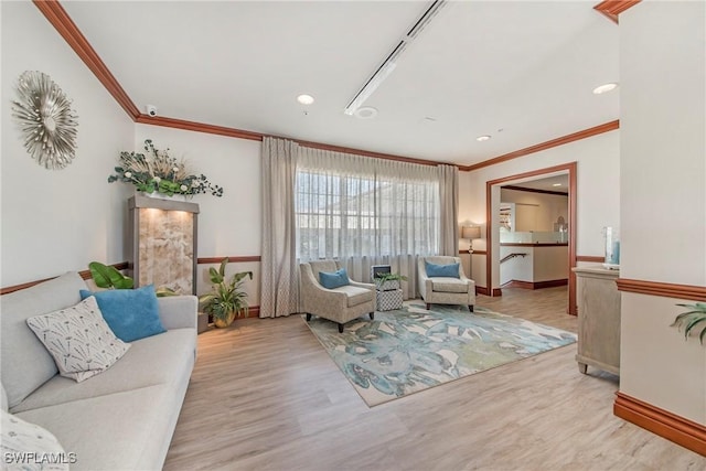 living room with light hardwood / wood-style floors and crown molding