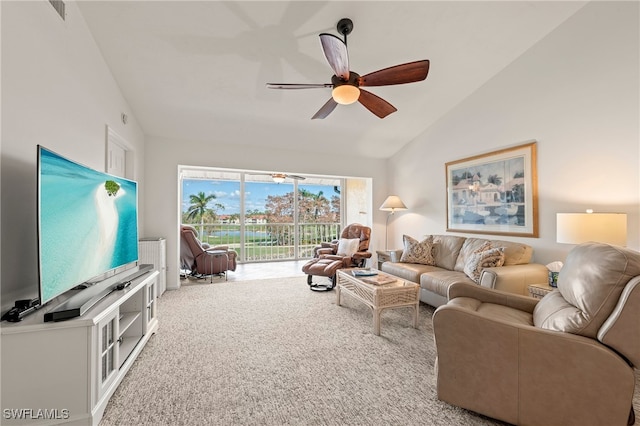 living room featuring carpet, ceiling fan, and vaulted ceiling