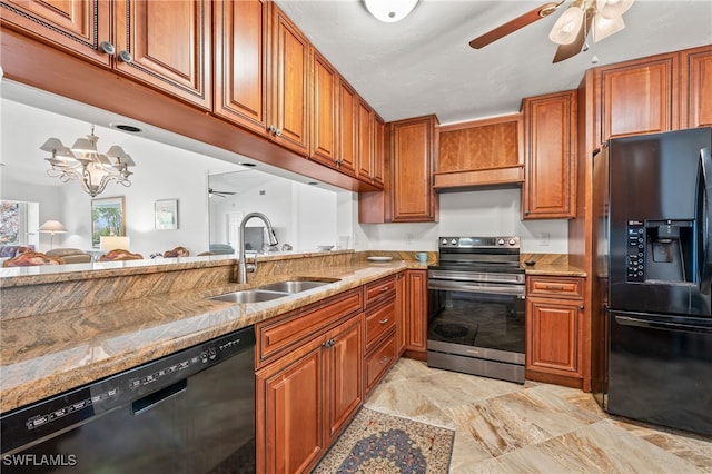 kitchen featuring black appliances, ceiling fan with notable chandelier, light stone countertops, and sink