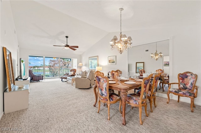 carpeted dining room with high vaulted ceiling and ceiling fan with notable chandelier