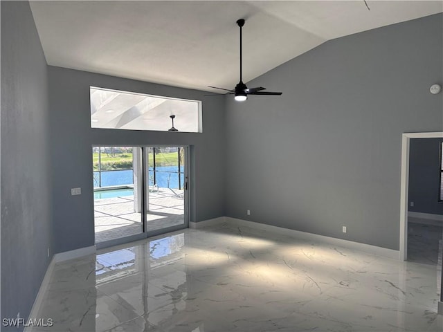 unfurnished room with ceiling fan, a water view, and vaulted ceiling