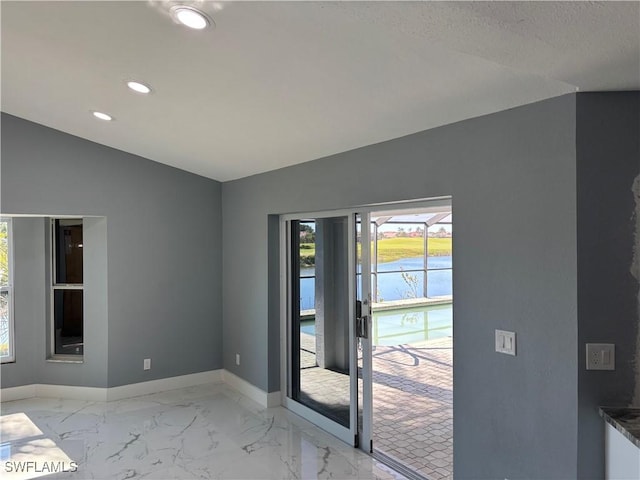 entryway featuring lofted ceiling