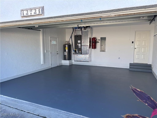 garage featuring electric panel, heating unit, water heater, and baseboards