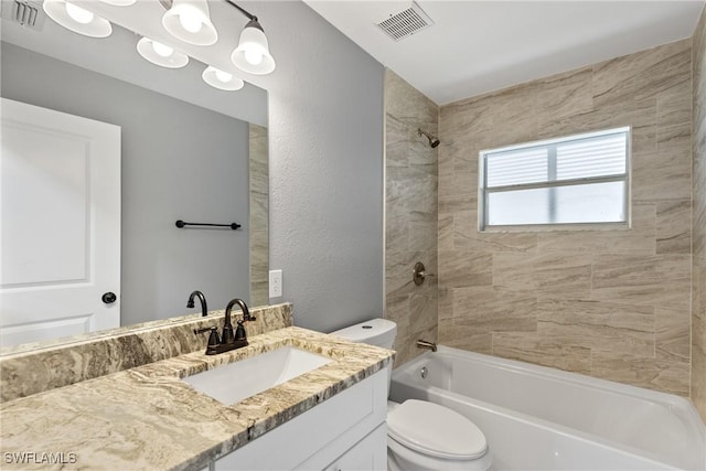 bathroom featuring toilet, tub / shower combination, vanity, and visible vents