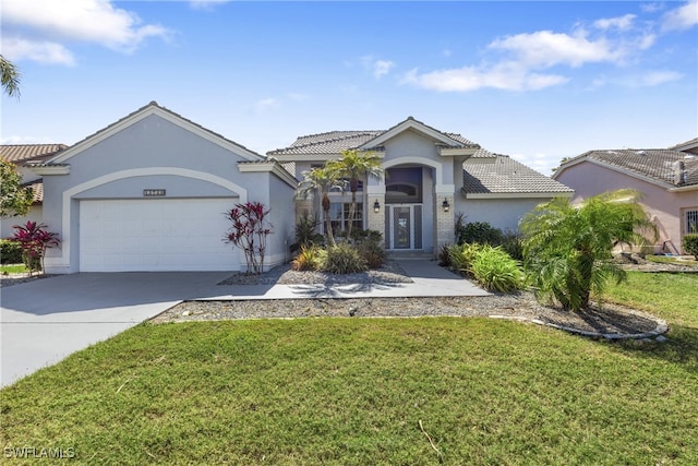 view of front facade featuring concrete driveway, a tiled roof, an attached garage, a front lawn, and stucco siding