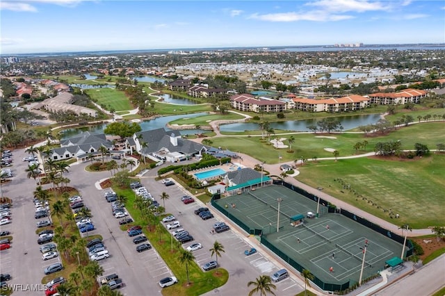 birds eye view of property featuring golf course view and a water view