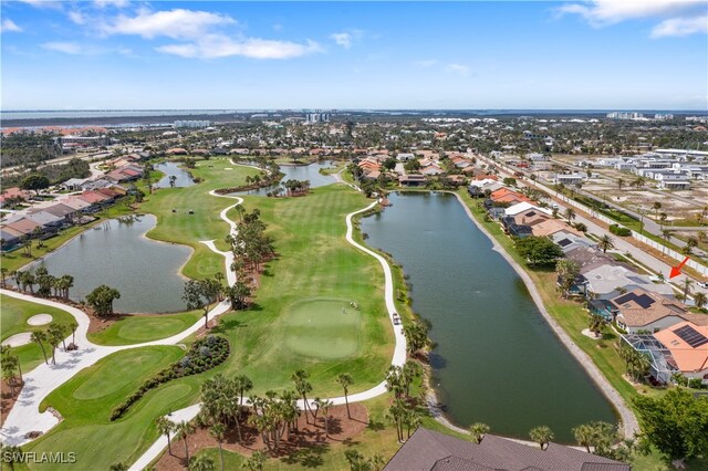 birds eye view of property with a water view and golf course view