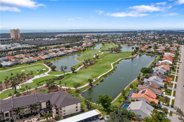 drone / aerial view with a residential view, view of golf course, and a water view