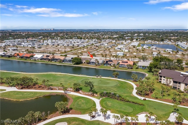 birds eye view of property featuring golf course view, a water view, and a residential view