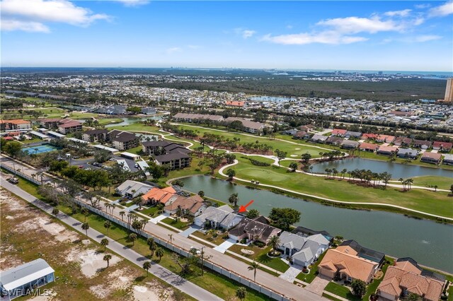 bird's eye view with a water view, view of golf course, and a residential view