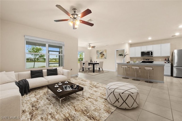 tiled living room featuring ceiling fan