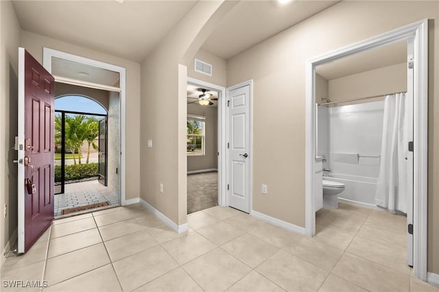 entrance foyer with ceiling fan and light tile patterned floors