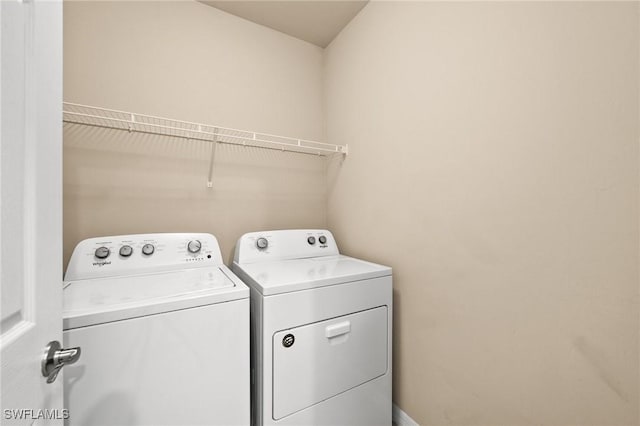 washroom with washing machine and clothes dryer