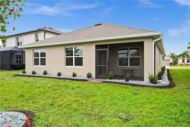 rear view of property with a lawn