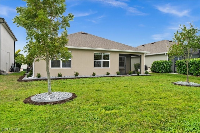 rear view of house featuring a lawn