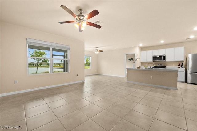 unfurnished living room with ceiling fan and light tile patterned floors