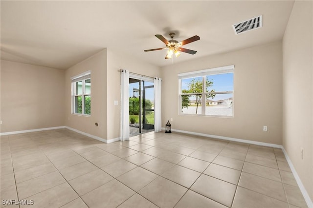 tiled empty room featuring ceiling fan