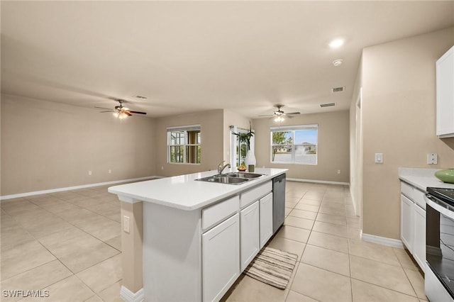 kitchen with a center island with sink, sink, light tile patterned floors, appliances with stainless steel finishes, and white cabinets