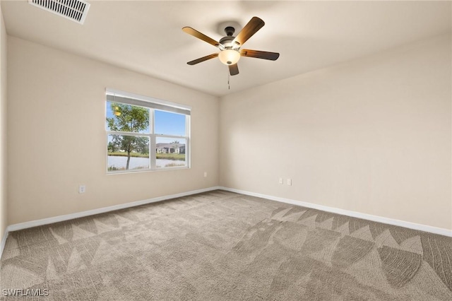 empty room featuring ceiling fan and carpet flooring