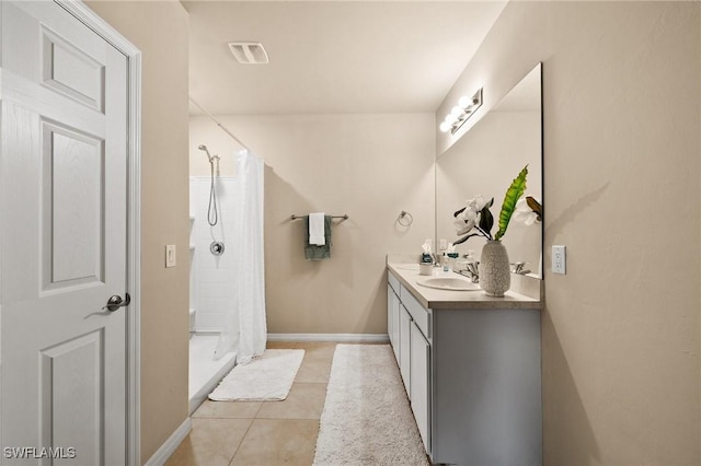 bathroom with a shower with shower curtain, tile patterned floors, and vanity