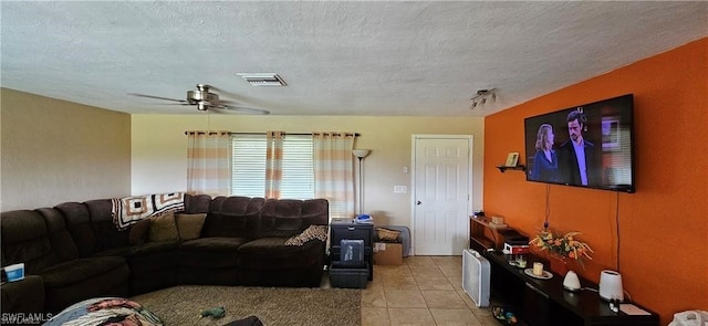 living room with light tile patterned floors, a textured ceiling, and ceiling fan