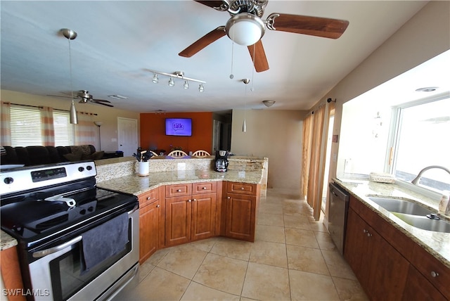 kitchen featuring stainless steel appliances, sink, light stone counters, light tile patterned flooring, and ceiling fan