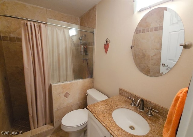 bathroom with vanity, tile walls, curtained shower, and toilet